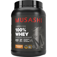 Black container of Musashi 100% Whey protein powder on a white background